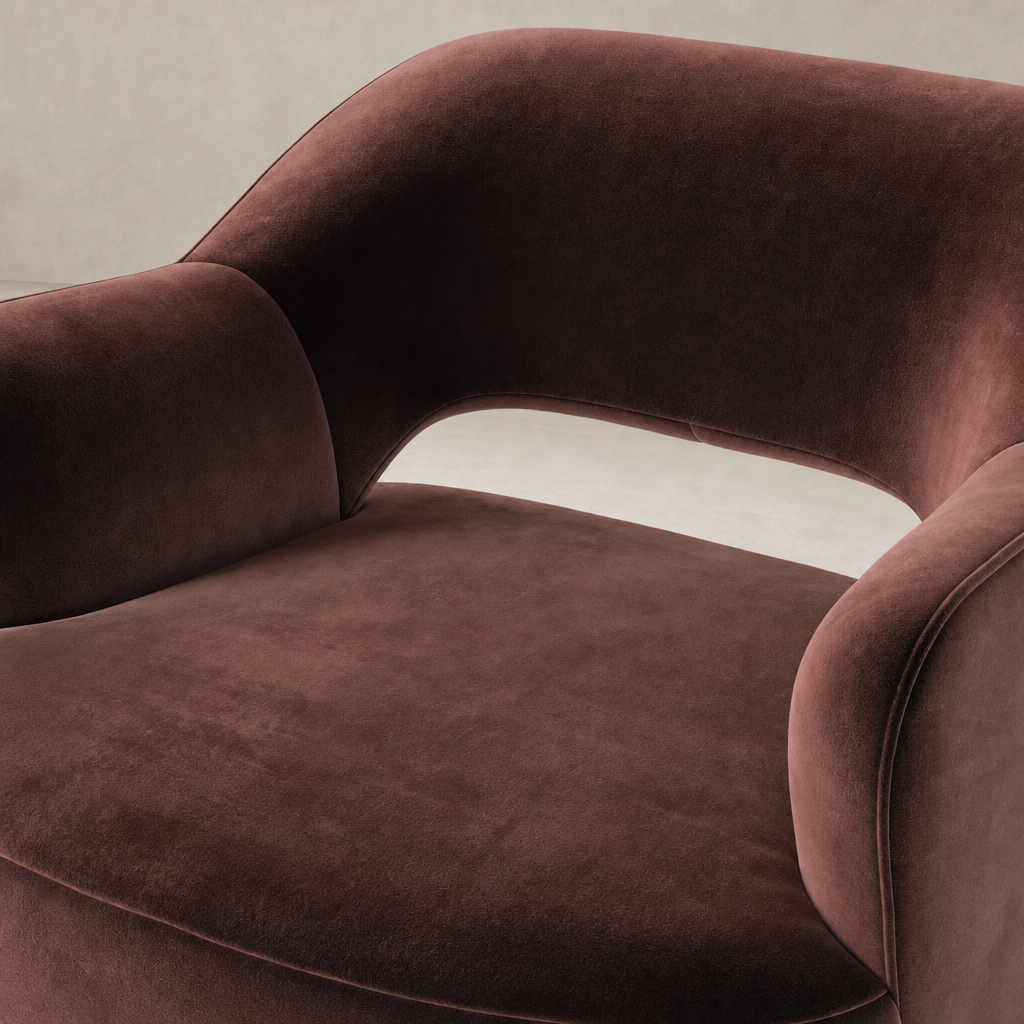 Amira Swivel Chair in Surrey Plum featuring a plush, curved design and soft upholstery.
