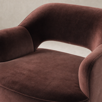 Amira Swivel Chair in Surrey Plum featuring a plush, curved design and soft upholstery.