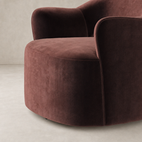 Amira Swivel Chair in Surrey Plum with soft, curved design and rich texture.