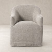Harbor Dining Chair With Casters in soft Heather Twill Stone fabric, featuring a rounded shape.