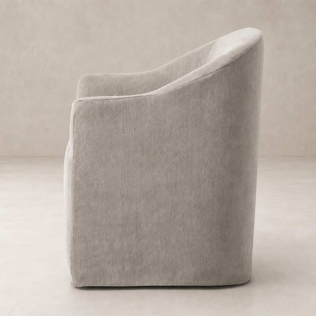 Harbor Dining Chair with Casters in heather twill stone showcasing a smooth, curved silhouette.