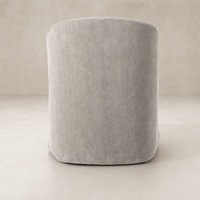 Harbor Dining Chair with Casters in Heather Twill Stone, featuring a sleek rounded back design.