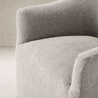 Close-up of the Harbor Dining Chair with Casters in Heather Twill Stone fabric, showcasing soft texture.