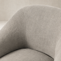 Close-up of the Harbor Dining Chair with Casters in Heather Twill Stone fabric, showcasing soft texture.