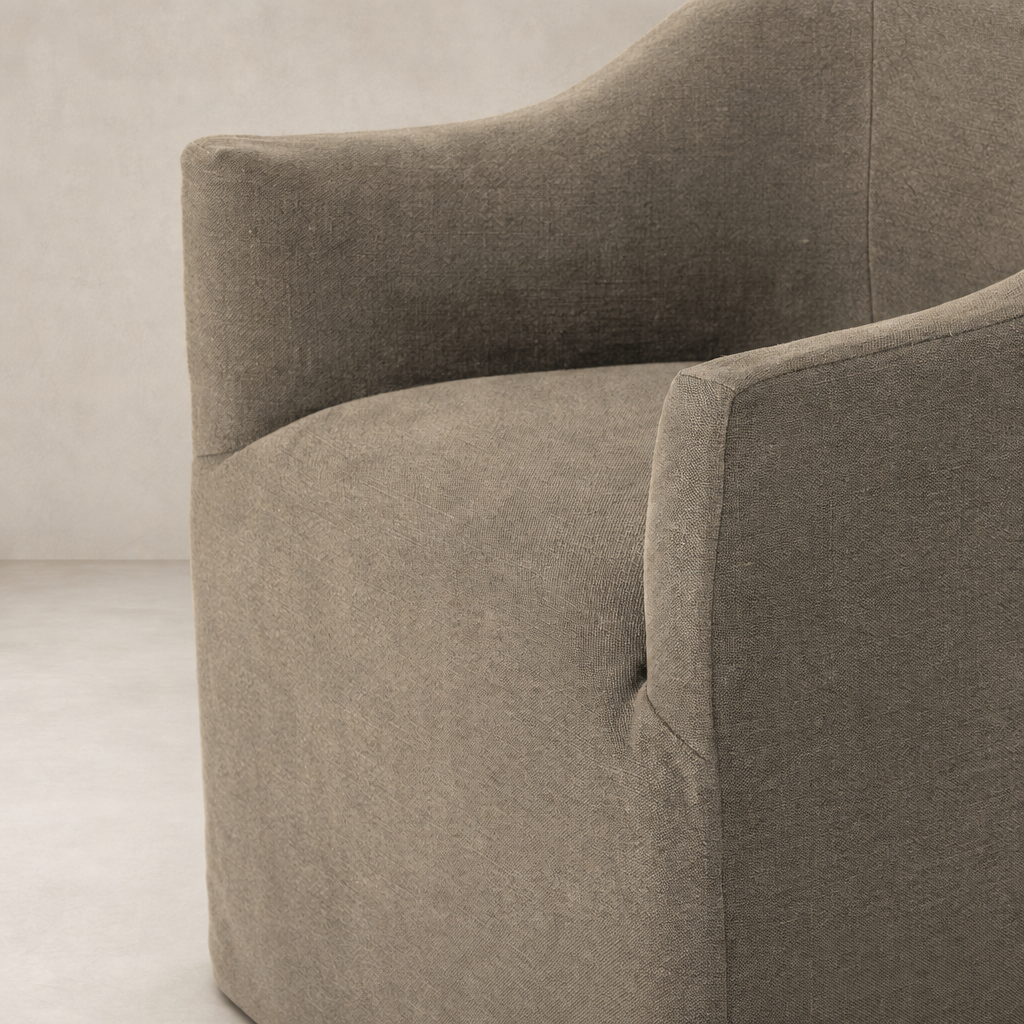 Harbor Dining Chair with Casters in Broadway Coffee featuring curved arms and soft fabric.