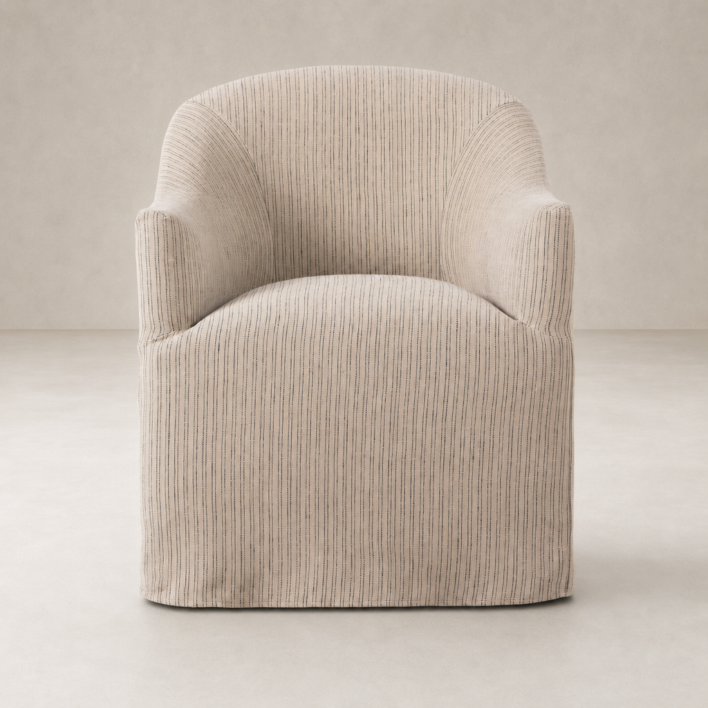 Harbor Dining Chair With Casters in Laine Navy features a sleek, curved design with soft upholstery.