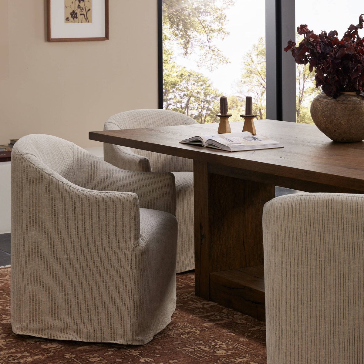 Harbor Dining Chair with Casters in Laine Navy, featuring a modern design and soft upholstery.
