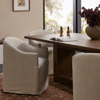 Harbor Dining Chair with Casters in Laine Navy, featuring a modern design and soft upholstery.