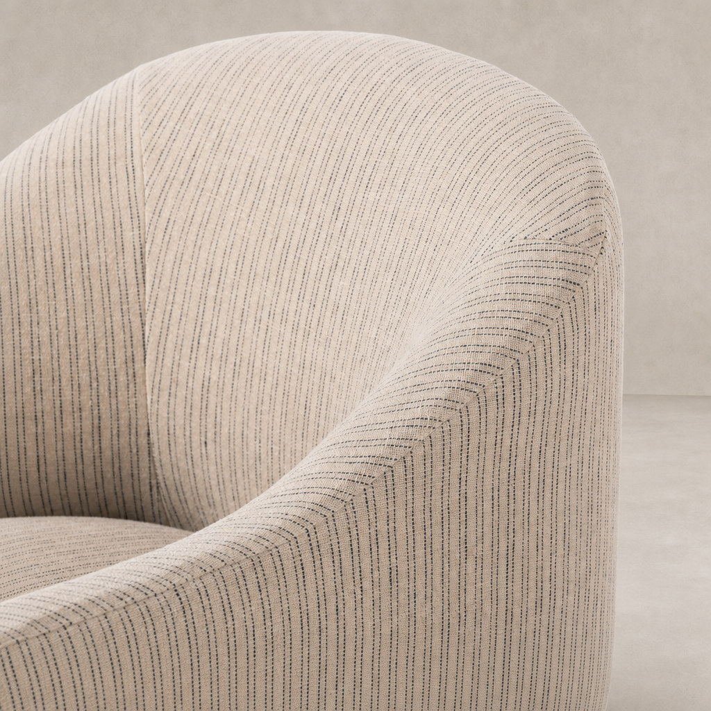 Detail of Harbor Dining Chair with Casters in Laine Navy fabric, showcasing textured upholstery.