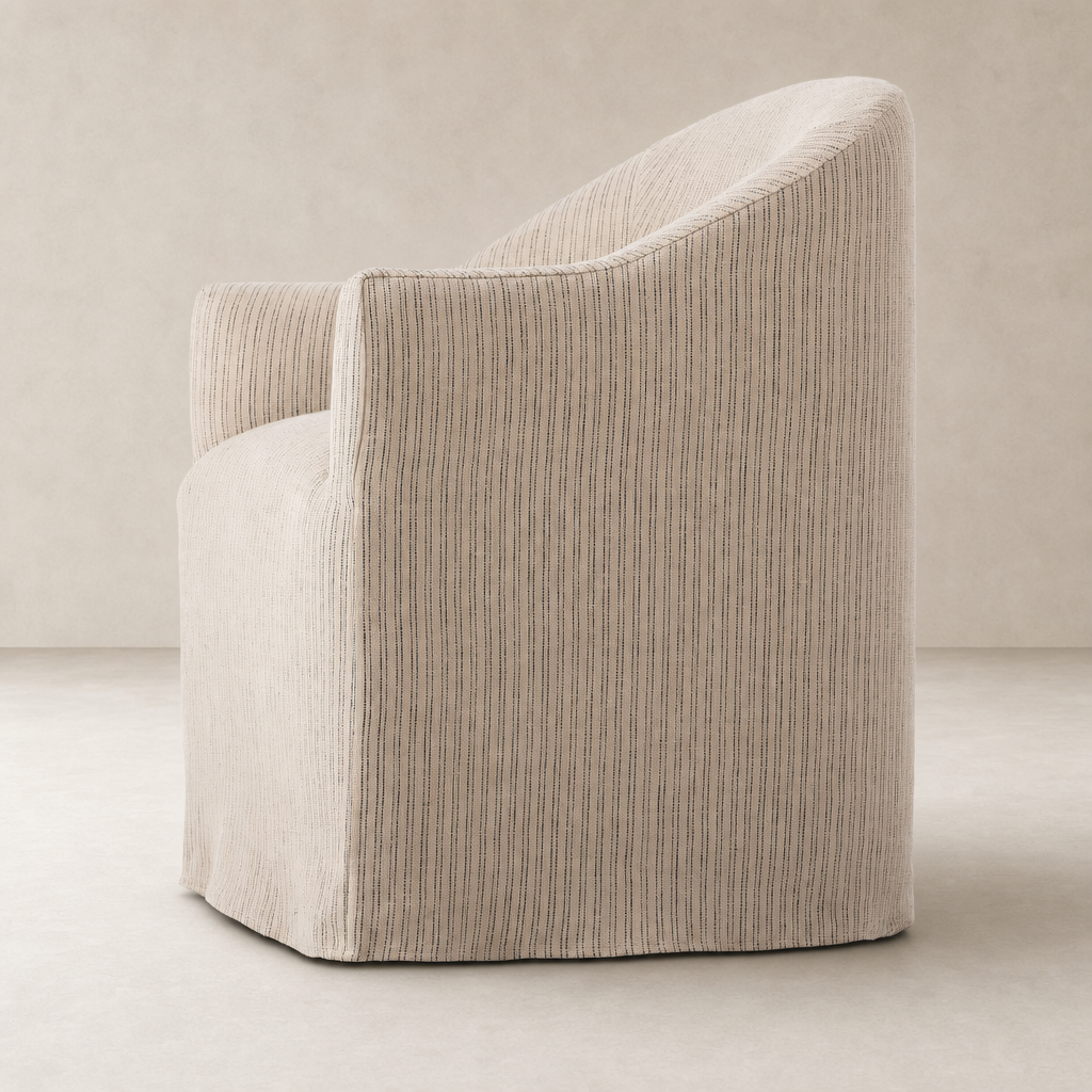 Harbor Dining Chair with Casters in Laine Navy, featuring a curved back and stylish design.