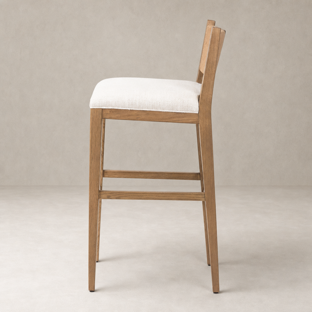 Ava Bar + Counter Stool in Dover Crescent with a sleek wooden frame and soft seat.