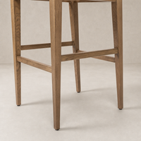 Ava Bar + Counter Stool in Dover Crescent featuring slender wooden legs and clean lines.