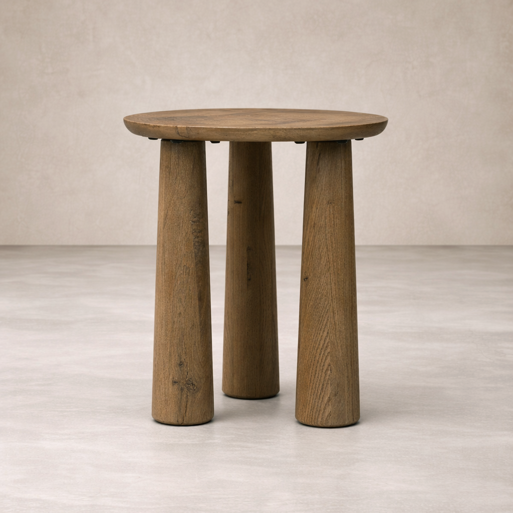 Close-up of the Drift Nesting End Table featuring a round top and sturdy, tapered wooden legs.