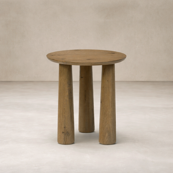 Front view of the Drift Nesting End Table featuring a round top and sturdy, textured wooden legs.