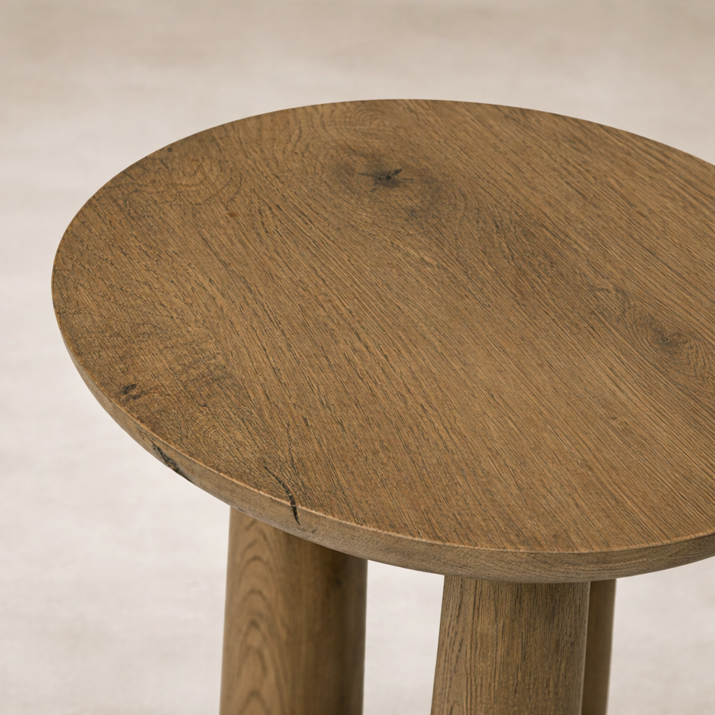 Detail of the Drift Nesting End Table showcasing a round, textured wood top with natural variations.
