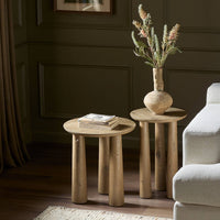 Rustic Drift Nesting End Tables in a cozy setting, featuring rounded tops and sturdy, cylindrical legs.