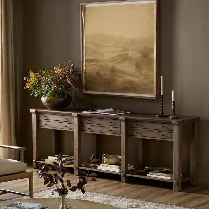 Willowdale Console Table in tan oak featuring three drawers and a sleek design.