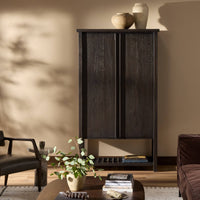 Smoked Black Tokyo Cabinet with sleek doors and minimalistic design in a cozy living room.