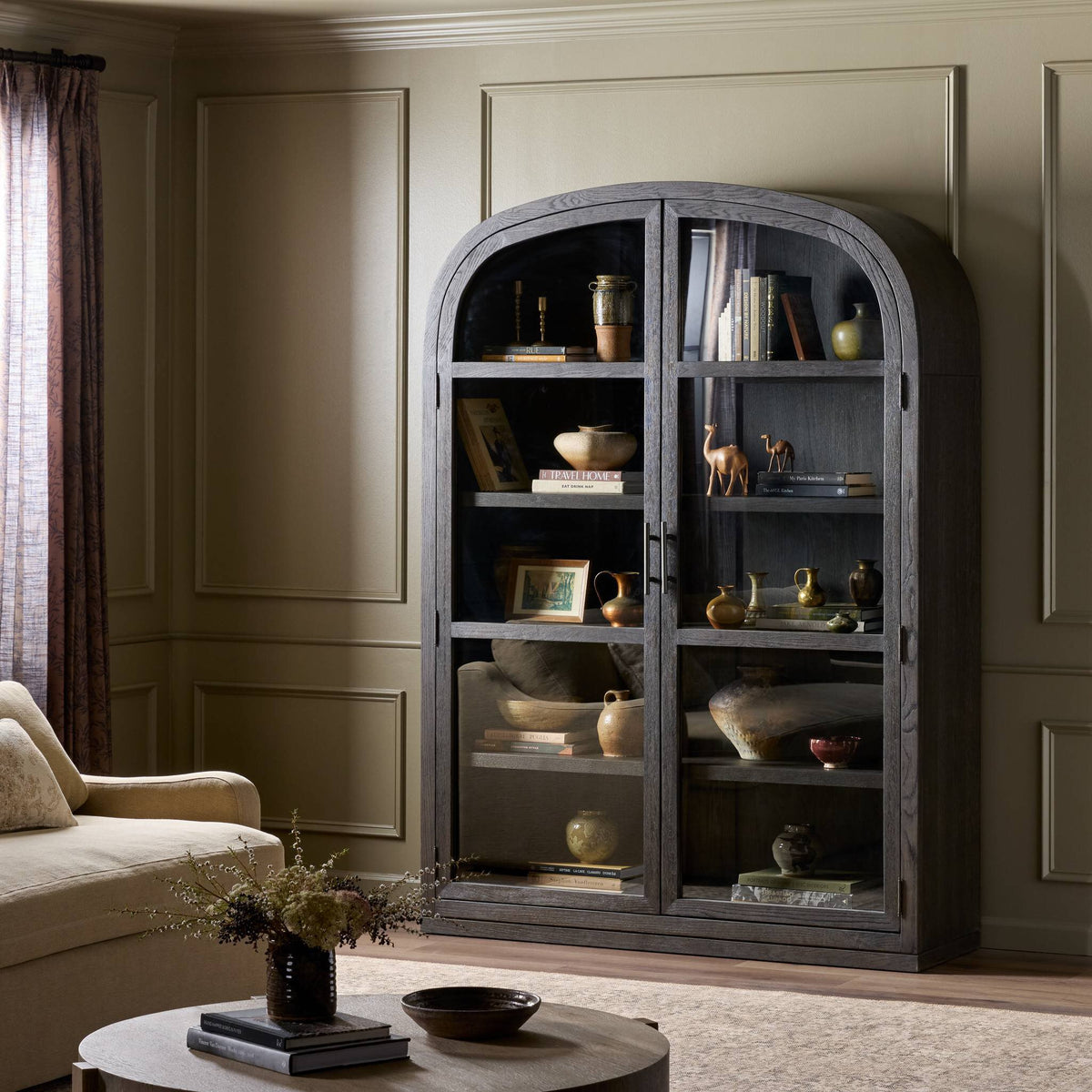 Wide cabinet in dark anthracite oak showcasing decorative items and books.