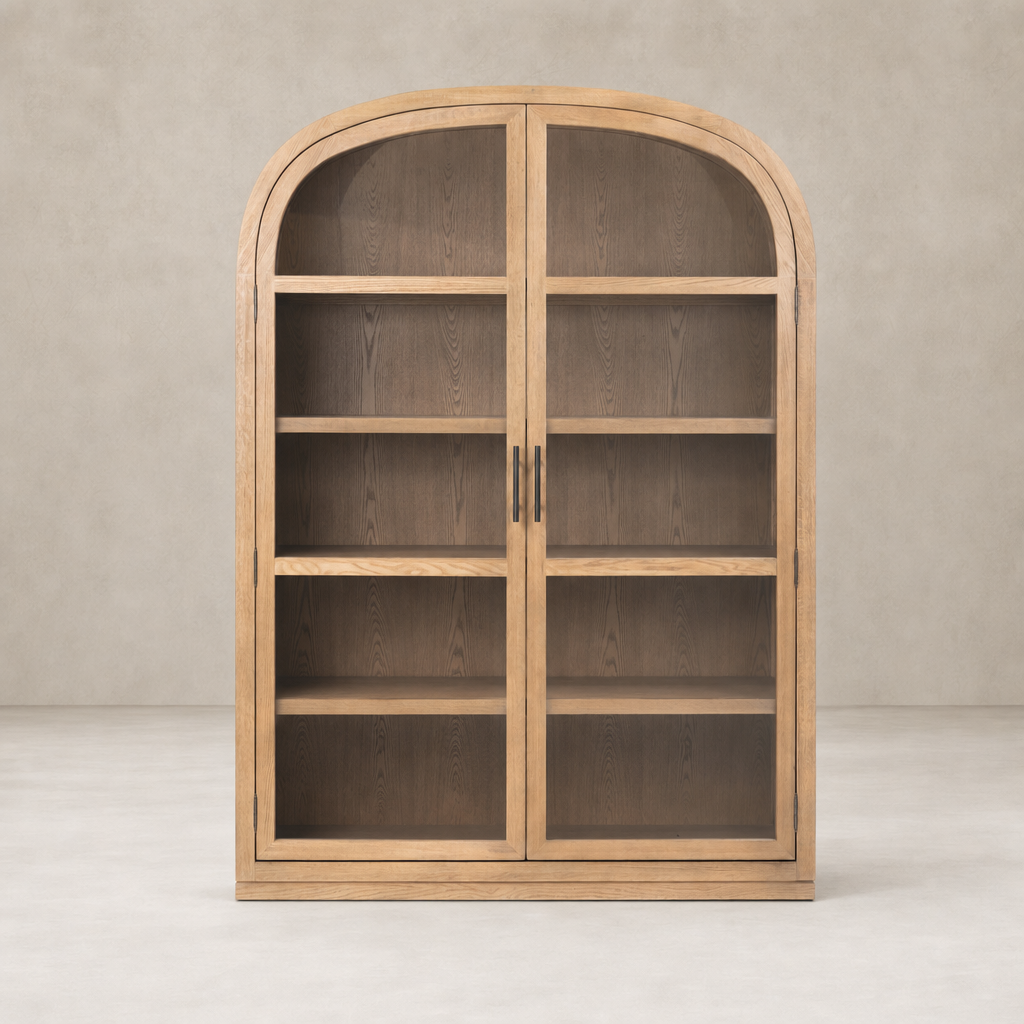 Wide cabinet in drifted smoked oak with arched top and double glass doors.
