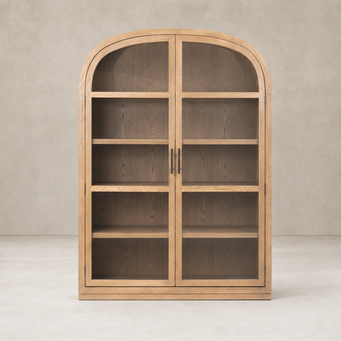 Wide cabinet in drifted smoked oak with arched top and double glass doors.