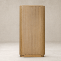 Beatrix Cabinet in Desert Oak featuring vertical grooves and a rounded base.