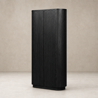 Beatrix Cabinet in cerused black oak with vertical grooves and rounded corners.