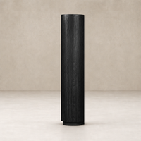 Beatrix Cabinet in cerused black oak with vertical ribbed texture and cylindrical shape.
