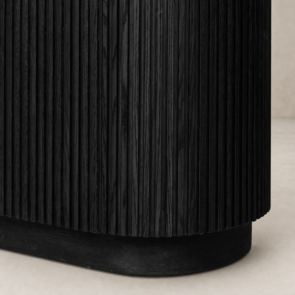 Beatrix Cabinet in cerused black oak featuring vertical ribbed texture and curved base.