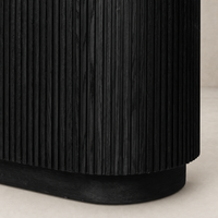 Beatrix Cabinet in cerused black oak featuring vertical ribbed texture and curved base.
