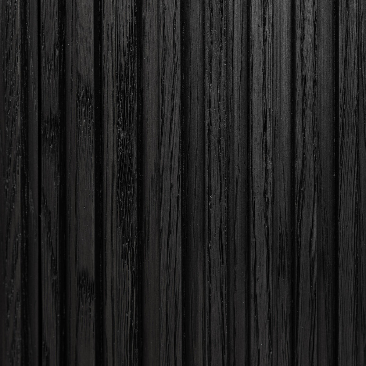 Close-up of the textured finish of the Beatrix Cabinet in cerused black oak.