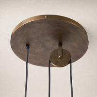 Burnished brass aluminum pendant with a round ceiling mount and sleek wire design.
