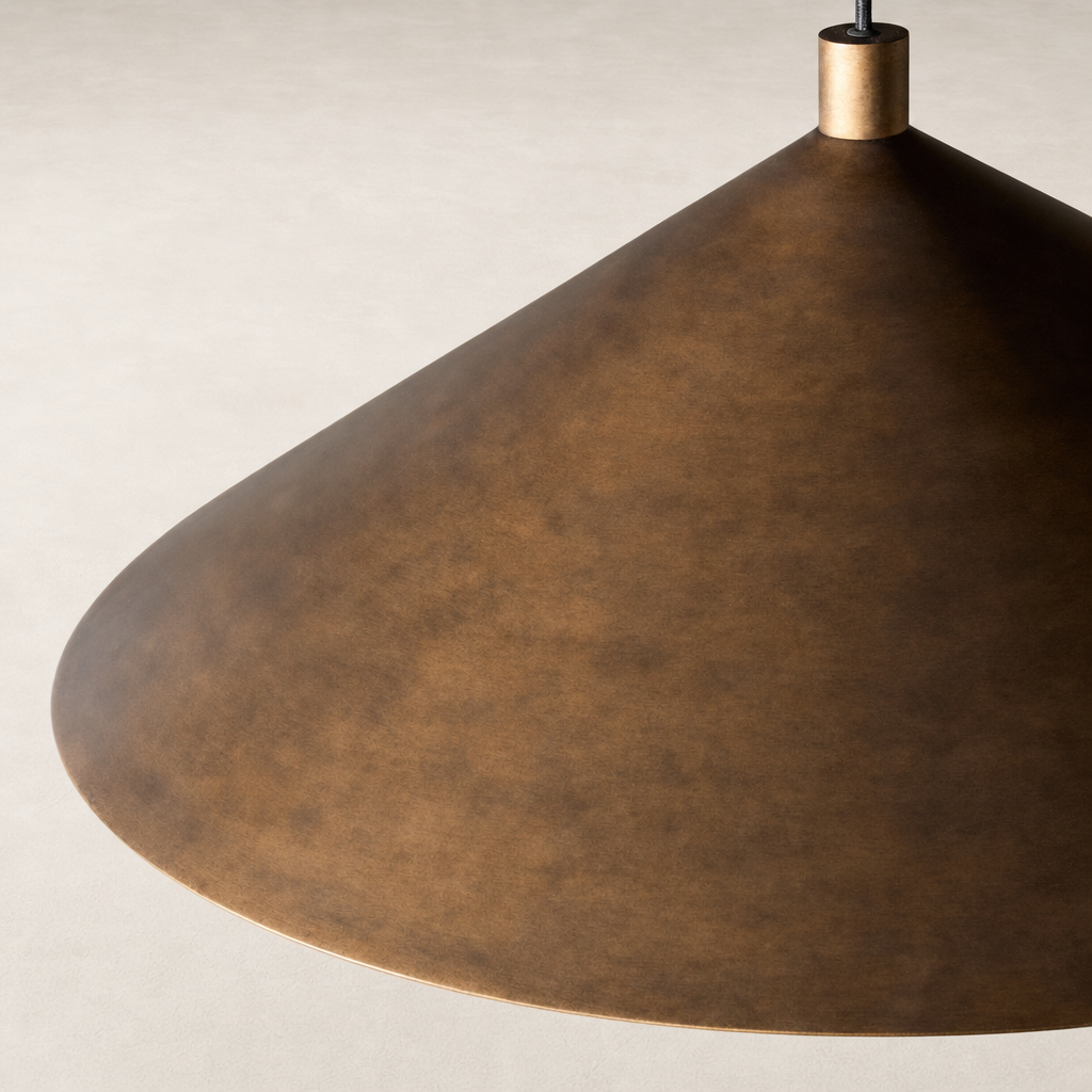 Burnished brass aluminum pendant light with a sleek conical design.