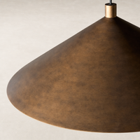 Burnished brass aluminum pendant light with a sleek conical design.