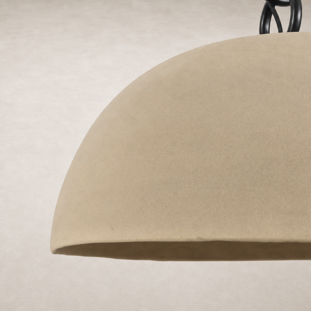 Tan speckled ceramic pendant light with a smooth, curved shape and black accents.