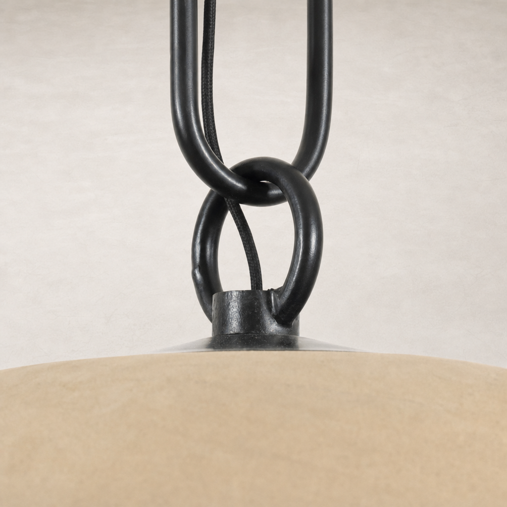 Tan speckled ceramic pendant light with black metal chain detail.