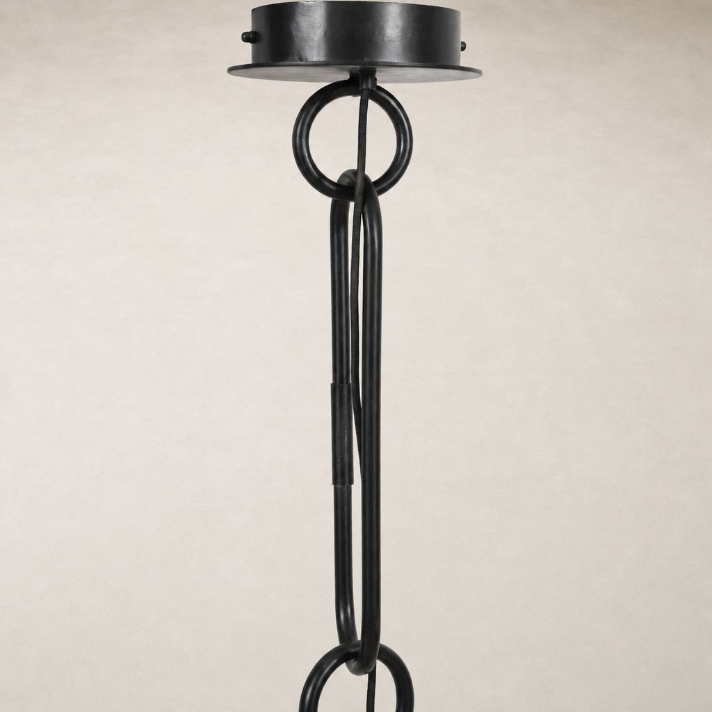 Tan speckled ceramic pendant light with a modern black hanging design.