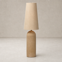 Tan speckled ceramic floor lamp with a conical fabric shade, showcasing a minimalist design.