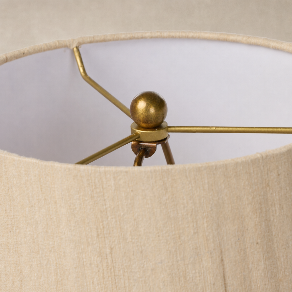 Tan speckled ceramic floor lamp with a modern brass socket and shade detail.