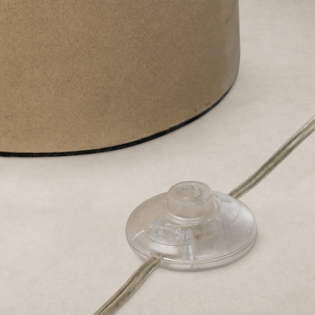 Tan speckled ceramic floor lamp base with a clear switch and cord.