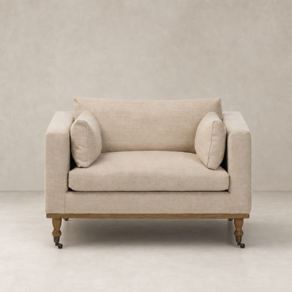 Savannah Chair in Alcala Wheat with plush cushions and wooden legs.