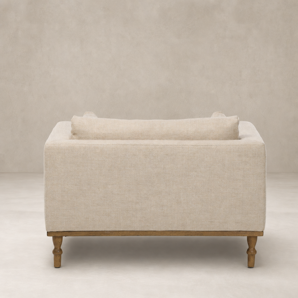 Savannah Chair in Alcala Wheat with plush back cushion and wooden legs.