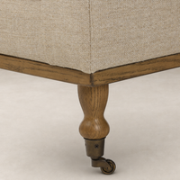 Savannah Chair in Alcala Wheat featuring a sturdy wooden leg with caster wheel.
