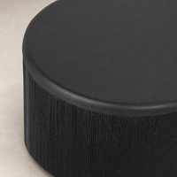 Roselle End Table in black with a textured cylindrical base and smooth top surface.