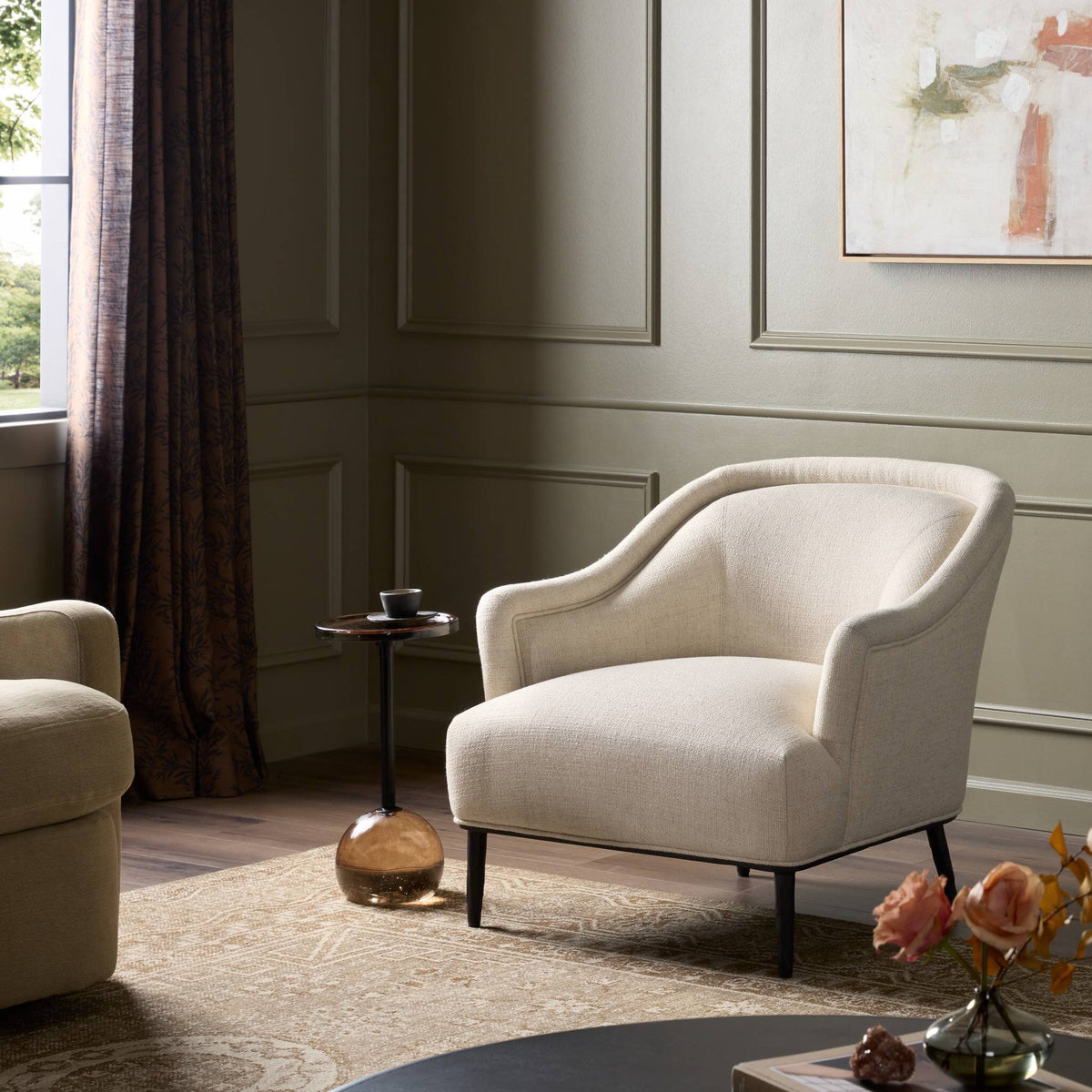 Wells Chair in Thames Cream featuring curved arms and soft fabric in a styled living room.