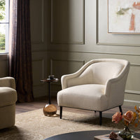 Wells Chair in Thames Cream featuring curved arms and soft fabric in a styled living room.