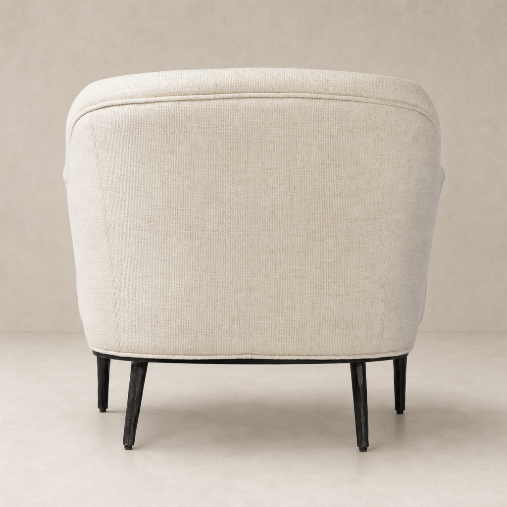 Wells Chair in Thames Cream with a rounded back and sleek black legs.