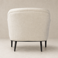 Wells Chair in Thames Cream with a rounded back and sleek black legs.