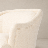 Wells Chair in Thames Cream featuring a smooth, curved design and textured fabric.
