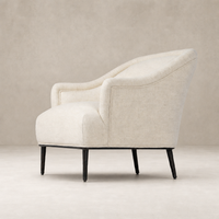 Wells Chair in Thames Cream featuring a curved silhouette and elegant upholstery.